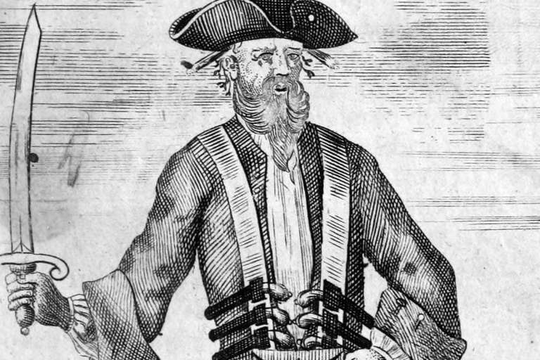 Picture of Blackbeard with several pirate weapons